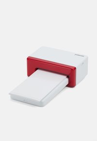 Compact portable printer in white and red plastic; features a paper output slot with stacked blank paper ready for printing.