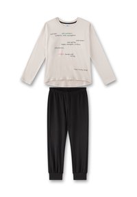 Light beige long-sleeve top with colorful text patterns, paired with black elastic waistband pants featuring ribbed cuffs at the ankles.