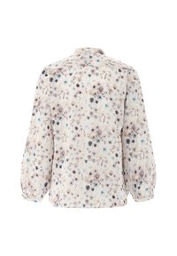 Floral blouse with a soft pastel pattern, featuring a round neck, long sleeves, and a slightly loose fit. Light fabric with texture variations.