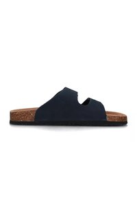 Sandalo in pelle nera con suola in sughero, design a ritaglio e suola piatta in gomma. Silhouette semplice senza ulteriori abbellimenti.