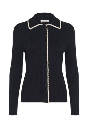 Must mustriga kardigan pikkade varrukatega, kreemjatest lainelistes äärtes kaeluses ja nööpide joones, ning mustad nööbid esiküljel.