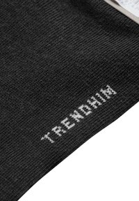 Tessuto a maglia nero con superficie texturizzata; presenta il testo bianco "TRENDHIM" lungo il bordo, suggerendo dettagli di branding o logo.