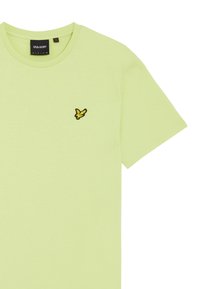 T-shirt in cotone verde chiaro con maniche corte, caratterizzato da un piccolo logo di un uccello giallo ricamato sul lato sinistro del petto. Design con collo rotondo.