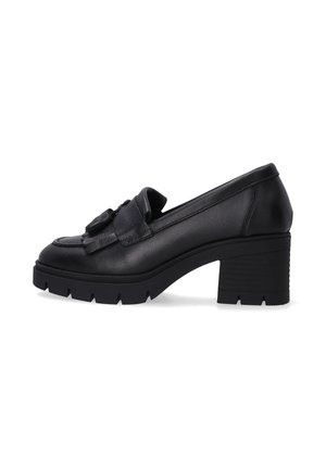 Black heeled loafers featuring a textured leather upper, prominent tassel detail, and a chunky treaded sole for added grip and stability.