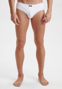 Witte katoenen heren boxershorts met een aansluitend ontwerp, elastische tailleband met een label aan de voorkant. Soepele textuur, minimalistische stijl.