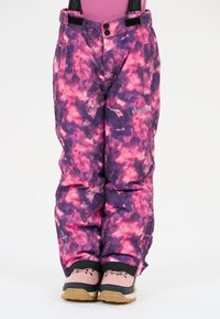 Purple and pink patterned snow pants with shoulder straps, featuring a soft texture and two pockets, worn with beige and pink boots.
