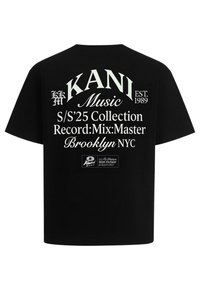 Black cotton t-shirt with white text featuring "KANI Music," collection details, and a logo. Short sleeves and a straight fit design.