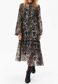 Robe maxi à manches longues, base noire, motif floral cachemire en bleu, or et crème. Comprend des détails à volants et une jupe à étages.