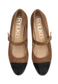 Brown suede Mary Jane shoes with a black leather toe cap, featuring a small strap with a buckle and a smooth beige insole.