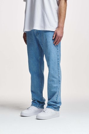 Light blue denim jeans with a relaxed fit, visible stitching, and a slightly faded texture, paired with white sneakers.
