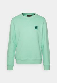 Mintgrön sweatshirt tillverkad av mjukt tyg, med rundad halsringning, ribbade muddar och en liten logotyp på vänster bröst.