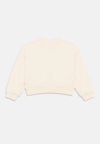 Μπεζ cropped φούτερ με ριμπ λαιμόκοψη και μανσέτες. Διαθέτει μικρό ροζ λογότυπο στην αριστερή μανσέτα. Μαλακή υφή υφάσματος.