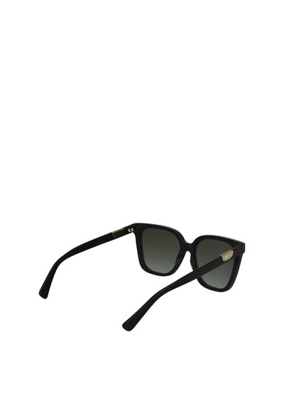 Occhiali da sole neri oversize con montatura squadrata, lenti grigie sfumate, texture opaca, dettaglio dorato sulla tempia e bracci curvi.