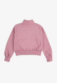 Rosa cropped sweatshirt med lange, puffete ermer, høy hals og teksturert stoff. Har strikket liv og minimal detaljering.