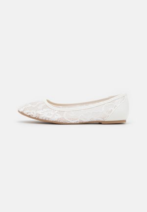 Zapato plano blanco de encaje con puntera puntiaguda y contrafuerte sólido, mostrado de lado sobre un fondo liso.