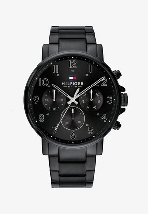 Mustmustronograaf kell, millel on roostevabast terasest korpus ja võrkkumm. Omab musta kell face'i, suuri araabia numbreid ja kolme aladeal.