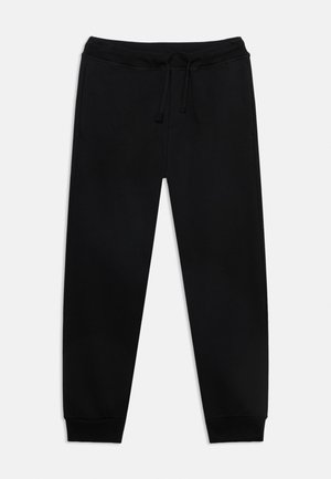 Pantalon de survêtement noir avec taille élastique et cordon, jambes fuselées et chevilles élastiquées sur un fond clair uni.