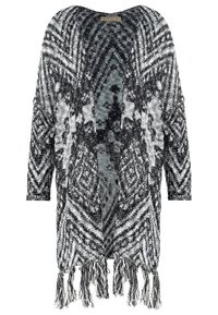 Cardigan de style kimono à motifs noir et blanc, avec une ouverture sur le devant, des manches longues et un ourlet à franges. La texture tricotée ajoute du détail.