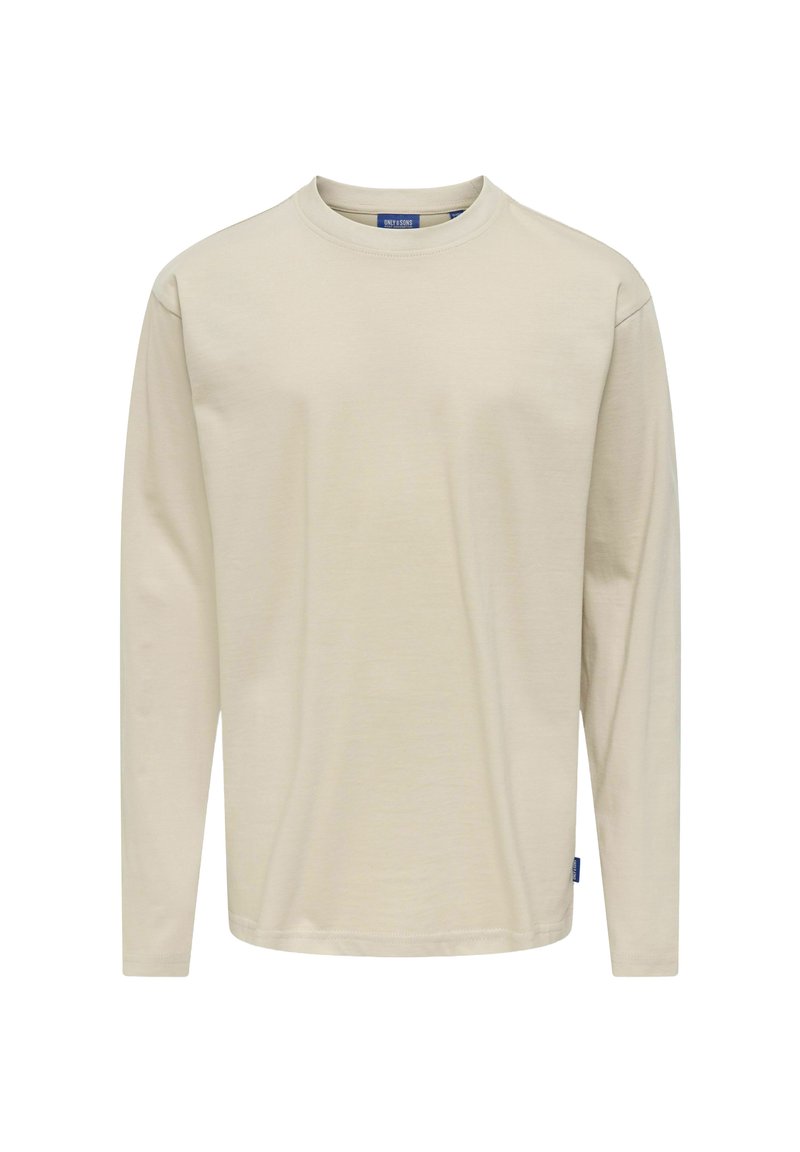 Beżowa bawełniana koszula z długim rękawem i okrągłym dekoltem. Posiada wszywane rękawy oraz małą niebieską metkę marki na dolnej stronie.