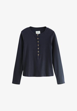Maglia henley a manica lunga blu navy realizzata in tessuto a coste, con scollatura tonda e sette bottoni in legno sul davanti.