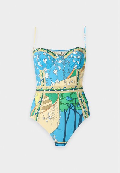 Maillot de bain une pièce bleu et beige avec fines bretelles, présentant un motif inspiré par la nature avec des feuilles, des arbres et des motifs abstraits.