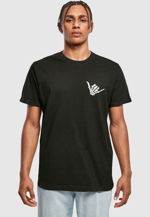 Black cotton t-shirt featuring a white skeleton hand graphic on the left chest. Short sleeves, relaxed fit, and smooth texture.