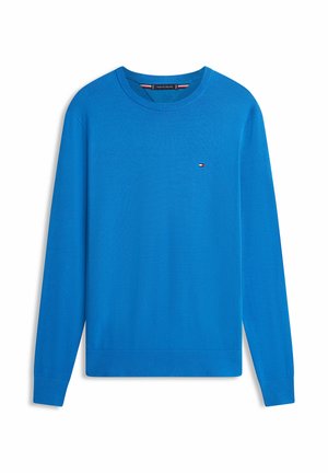 Jersey azul de manga larga con cuello redondo, puños y dobladillo acanalados, con un pequeño logo bordado en el pecho izquierdo.