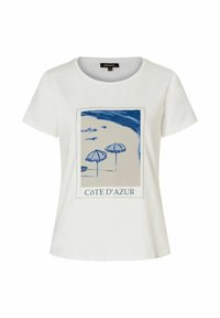Cotton t-shirt in white featuring a blue graphic of beach umbrellas. Print centered with "CÔTE D'AZUR" text at the bottom. Short sleeves.