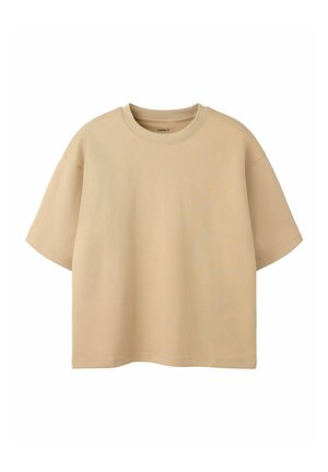 T-shirt beige oversize à manches courtes avec col rond, présenté sur fond blanc.