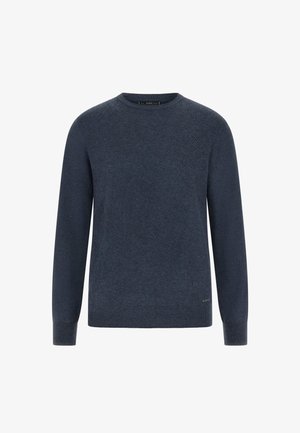 Tume sinine sviiter, ümmarguse kaelusega, tekstuurse kühmupatriikiga, ribatud varrukate ja äärega. Valmistatud pehmest kudumist materjalist.