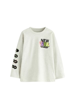 Sweatshirt à manches longues gris clair avec le texte « NEW YORK », des graphismes colorés et des phrases de mouvements de skateboard sur la manche gauche. Tissu doux.
