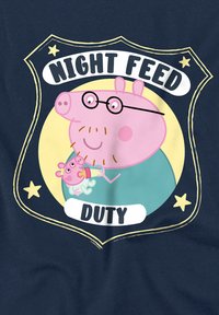 Navy t-shirt featuring cartoon characters: a pink pig with glasses and a baby pig, surrounded by a badge with text "NIGHT FEED DUTY."