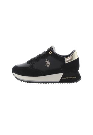 Black sneaker made of suede and synthetic material. Features white midsole, textured black sole, and a metallic silver heel accent. logo on side.