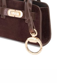 Brown suede handbag with smooth leather accents, gold hardware, and a circular keyring attachment. Compact rectangular shape.
