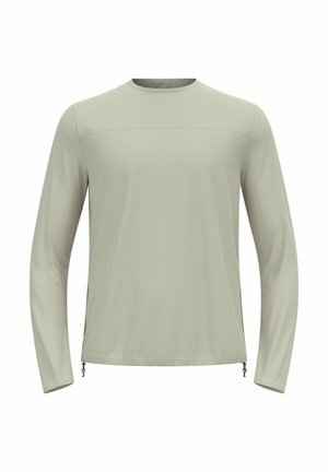 Lichtgrijze longsleeve shirt gemaakt van zachte, lichte stof. Kenmerkt zich door een ronde halslijn en zijritsen voor een verstelbare pasvorm.