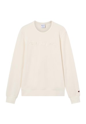 Felpa a maniche lunghe color crema con la scritta "Champion" ricamata sul petto e un piccolo logo Champion sul polsino sinistro.