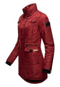 Red padded jacket with a high collar, zippered and buttoned front, multiple pockets, and black knit cuffs. Features logo patch on sleeve.
