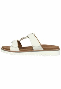 White leather sandal with two straps and a cushioned brown footbed. Features a thick white rubber sole with textured tread.
