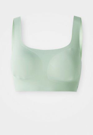 Reggiseno wireless verde chiaro, senza cuciture, con larghe spalline e coppe sagomate su sfondo bianco.