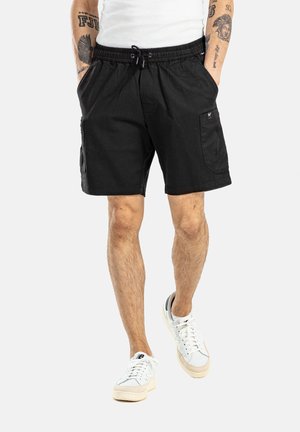 Pantalones cortos de algodón negros con cintura elástica y cordón, bolsillos laterales y un bolsillo tipo cargo en la pierna derecha.