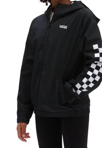 Black zip-up jacket with hood, featuring a white checkerboard pattern on the right sleeve and the Vans logo on the chest.Elastic cuffs.