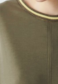 Olive green sweater with a textured finish, featuring a ribbed yellow and brown striped neckline and vertical seam detailing.