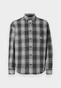 Juodai baltas langeliais marškinėliai su mygtukų apykakle, ilgomis rankovėmis ir mažuoju logotipu ant krūtinės. Pagaminta iš minkštos medžiagos su tekstūruota apdaila.