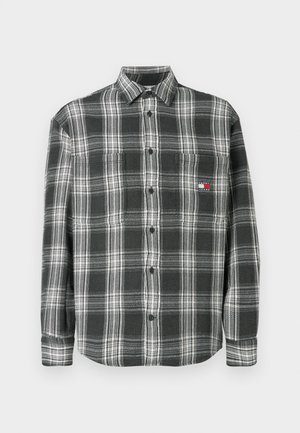 Černobílá kostkovaná košile s knoflíkovým límcem, dlouhými rukávy a malým logem na prsou. Vyrobena z měkké tkaniny s texturovaným povrchem.