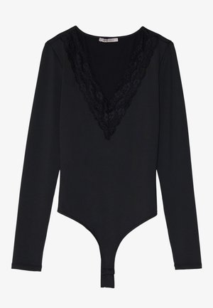 Black long-sleeve bodysuit made of smooth material, featuring a lace-trimmed V-neck and a snap closure at the bottom.