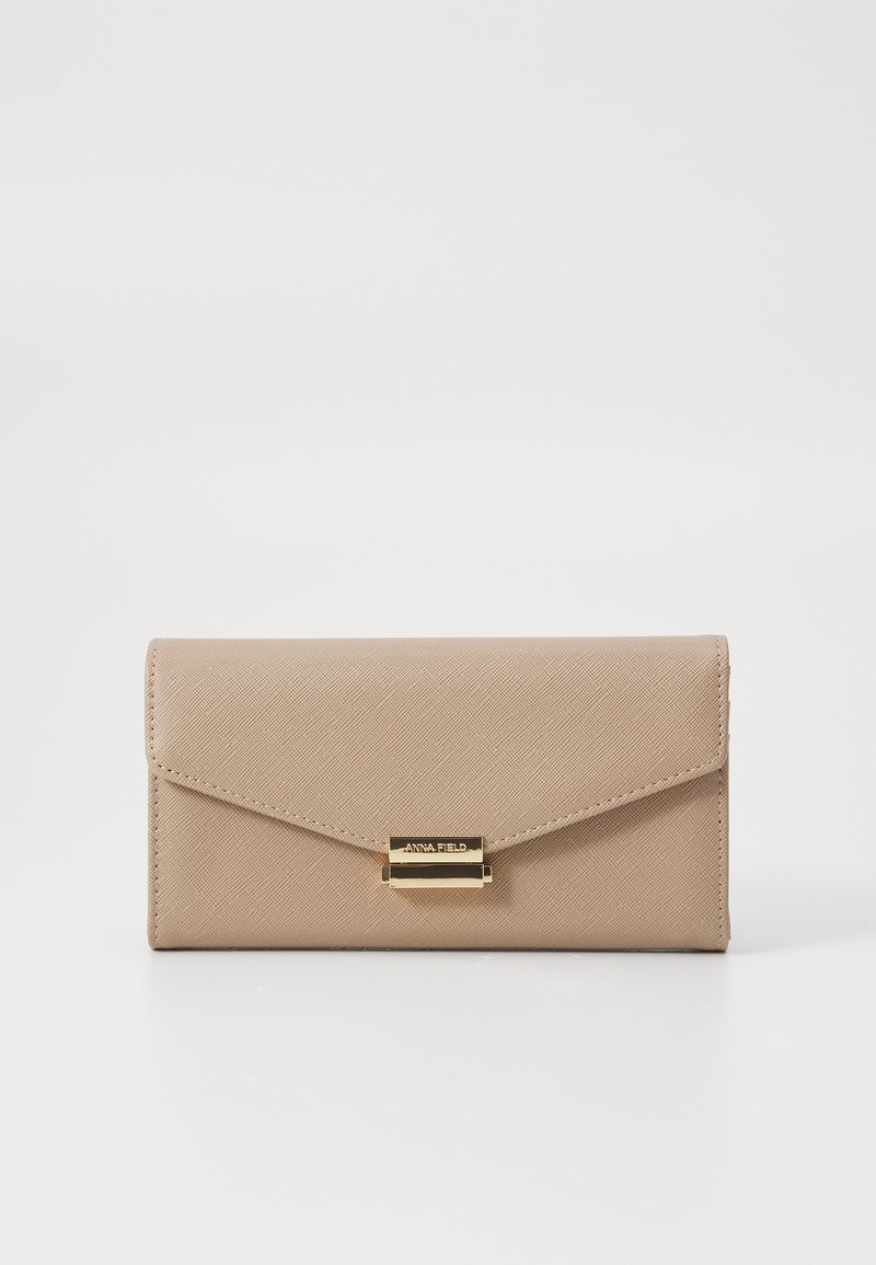 Beige wallet with an envelope design, textured surface, and a gold-tone clasp. Features a brand name plate on the front.