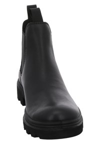 Botte Chelsea en cuir noir avec une tige lisse, des panneaux élastiques sur les côtés, une semelle en caoutchouc épaisse, et une languette pour un enfilage facile.