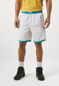 White athletic shorts with turquoise accents and side panels, featuring a mesh texture, elastic waistband, and a small logo on the front.