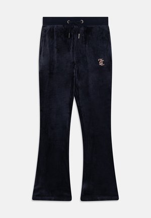 Navy blue flared sweatpants made of soft velvet material, featuring a drawstring waist and a rhinestone logo detail on the front.