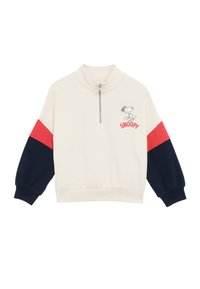 Sweatshirt à col montant couleur crème avec des manches à blocs de couleur bleu marine et rouge, présentant un col zippé à quart et un graphique de Snoopy avec le texte "SNOOPY".